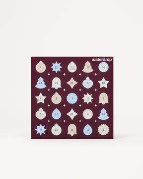 Advent calendar featuring 24 numbered door panels in a dark purple square on a light background.
